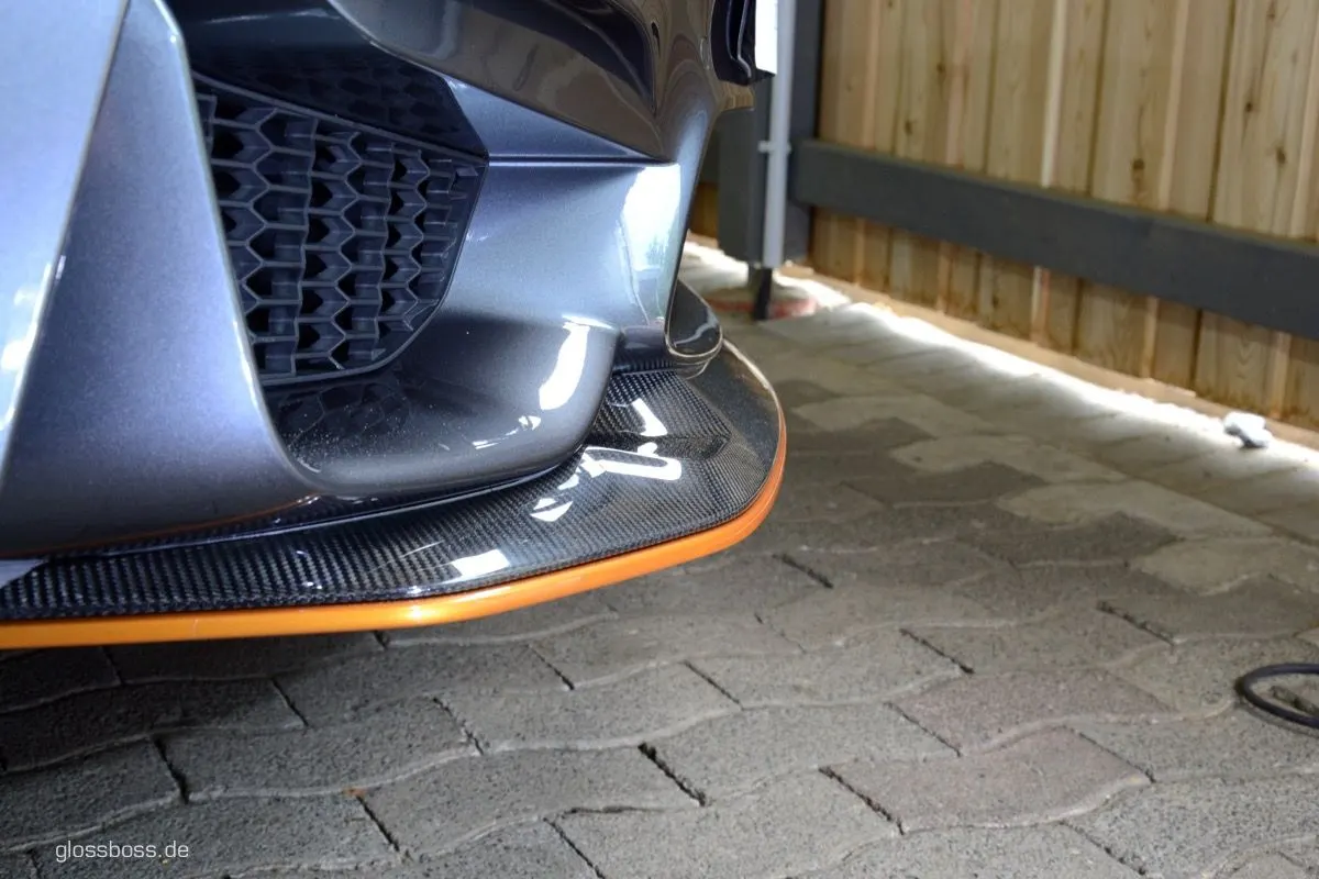 Close-up of a spotless front bumper and carbon splitter