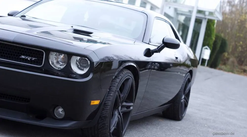 Black muscle car parked outside with a deep, glossy finish